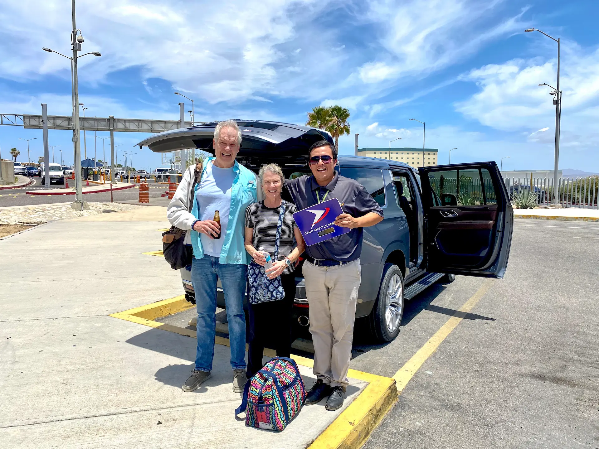 Thumbs Up happy grandpa with a beer outside SJD los cabos international airport terminal 2
